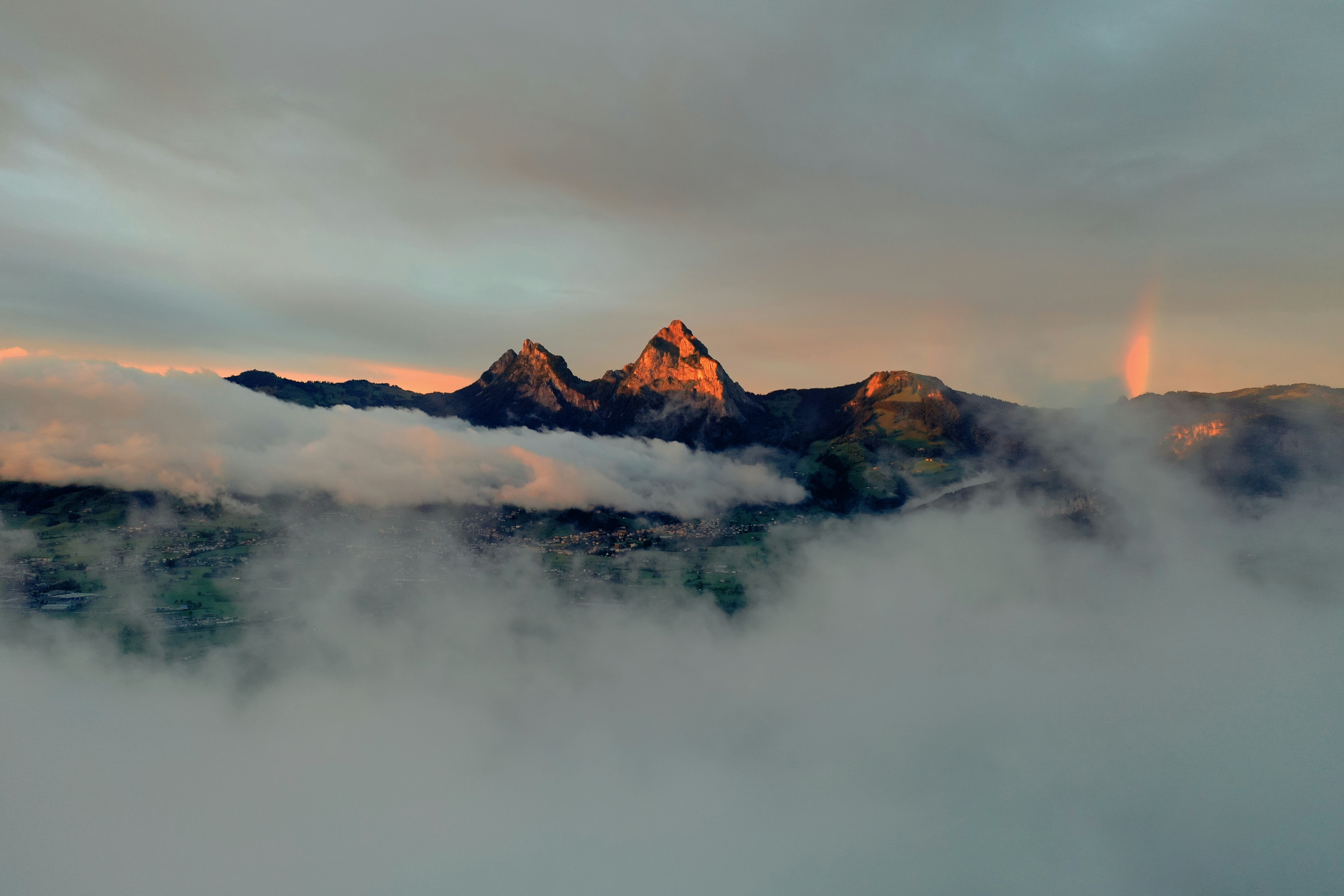 brown mountain covered by clouds